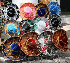 many different colored hats are on display in front of a storefront window stock photo - image