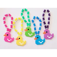 four beaded necklaces with different colored beads and designs on them, one has an angry bird