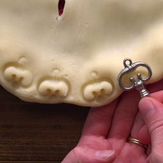 a person holding a key to a fake tooth