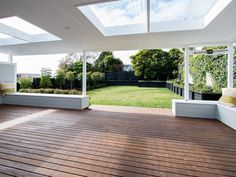 an outdoor living area with wood flooring and white walls