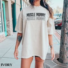 Know someone who is into weight lifting, fitness, and working out? Get them this muscle mommy pump cover t shirt! Our heavy blend shirts are made from 100% ring spun cotton and are double stitched on all seams as well as pre-shrunk for superior product durability. This shirt has a relaxed fit. For an oversized look or dress look, please size up. Purchase does not include photo props. ⭐Shipping ⭐ All of our products have free shipping. Our goal is to ship your order out as quickly as possible. On Oversized Letter Print Activewear For Workout, Muscle Mommy, Pump Cover, Gym Clothes Women, Gym Shirt, Oversized Look, Comfort Colors Shirt, Gym Shirts, Girlfriend Gift