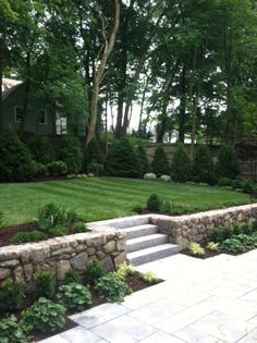 a large yard with stone steps and landscaping