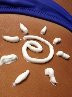 the stomach is covered in white icing and small pieces of food