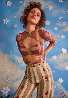 Playfully captivating, this co-ord set is crafted in multi-hued organza and features a round neckline with cutouts at the center, enhanced with floral trims and full sleeves. The top offers a contoured fit with a chic style, best paired with high-waisted straight pants for a polished and stylish look. Festive Sets With Sheer Sleeves And Organza Material, Festive Organza Sets With Sheer Sleeves, Festive Fitted Sheer Sets, Summer Party Organza Sets, Sheer Long Sleeve Sets For Summer, Sheer Long Sleeve Summer Sets, Sheer Spring Party Sets, Chic Festive Fitted Sets, Chic Fitted Festive Set