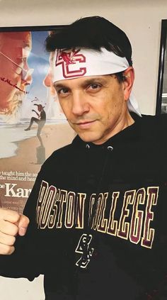 a man in a black shirt and white headband