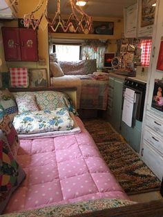 the inside of a camper with lots of furniture and decor on display in it