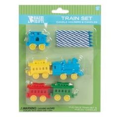 three colorful train candles in plastic packaging