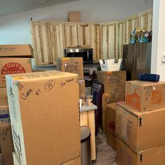 many boxes are stacked up in the kitchen