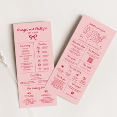 two pink wedding program cards on a white table