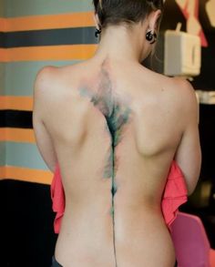 the back of a woman with tattoos on her body