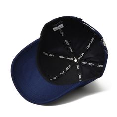 a black and blue hat with white letters on it