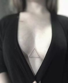 a woman with a triangle tattoo on her chest