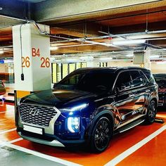 two suvs parked in a parking garage next to each other