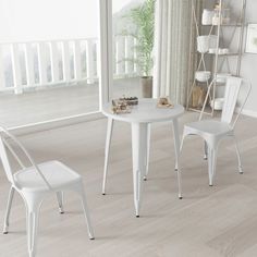 a white table and two chairs in a room