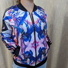 Adidas Originals Florera Superstar Optic Bloom Track Jacket Ab1986 Nwot Size: Small Description: A Vibrant Kaleidoscopic Print Brings A Burst Of Colour To The The Classic Superstar Track Jacket. This Women’s Tricot Version Features The Trefoil On The Back. Casual Multicolor Adidas Outerwear, Trendy Purple Outerwear, Trendy Adidas Outerwear For Spring, Adidas Multicolor Long Sleeve Outerwear, Starter Jacket, Adidas Jackets, Blue Adidas, Track Jacket, Track Jackets