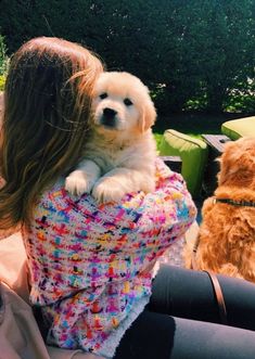 a woman holding a dog in her arms