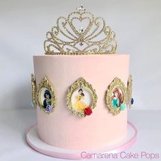 there is a pink cake with princess pictures on the top and gold trimmings