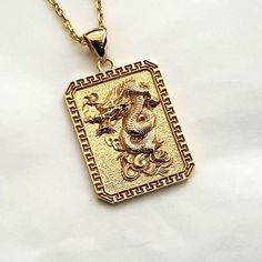 men's korean dragon necklace pendant 2 made in real 14k solid gold or real 18k solid gold the korean dragon with exquisite details is on this pendant. - the pendant height is 26mm without the bail. - model wears a 14k 1.7mm 50cm chain. - materials: real 14k solid gold, real 18k solid gold - free shipping on all orders via fedex! - designed by carre d'or - made in south korea 14k gold dragon pendant necklace 2 weight pendant only 7.84g (±3%) with 2.1mm 42cm chain 13.80g (±3%) with 2.4mm 42cm chain 15.67g (±3%) with 3.0mm 42cm chain 19.42g (±3%) 18k gold dragon pendant necklace 2 weight pendant only 9.34g (±3%) with 2.1mm 42cm chain 15.74g (±3%) with 2.4mm 42cm chain 17.75g (±3%) with 3.0mm 42cm chain 21.78g (±3%) Mens Necklace Gold, Gold Round Pendant With Dragon Design, Korean Dragon, Yellow Gold Dragon Design Jewelry Gift, Gold Dragon Design Round Pendant Jewelry, Gold Necklace With Dragon Design Collectible, Gold Fantasy Dragon Necklace, Men's Necklace Gold, Yellow Gold Dragon Design Pendant Jewelry