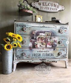 an old dresser with flowers on the bottom