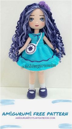 the doll is wearing a blue dress and purple shoes