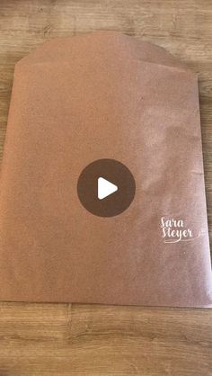 a brown paper bag sitting on top of a wooden table