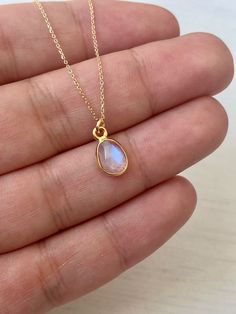 Rainbow Moonstone Necklace, Solid Gold Necklace, 14K Gold, June Birthstone, Small Moonstone Pendant, Anniversary Gift, Birthday gift for her Classic, Minimalist and Every Day Necklace featuring a small blue flash Rainbow Moonstone Pendant measuring 10 x 6 mm framed bezeled in solid 14k yellow gold. Pendant is suspended from a solid 14k gold cable chain. You can switch lengths at any time with 3 sizes to choose from: 16, 17 or 18 inches. All elements of this necklace are 100% SOLID Gold. They wil Gold Moonstone Necklaces For Anniversary, Gold Moonstone Necklace For Anniversary, Moonstone Briolette Necklace For Gift, Briolette Moonstone Necklace For Gift, Dainty Moonstone Necklace For Anniversary, Moonstone Birthstone Necklace Gift, Delicate Moonstone Necklace For Anniversary, Bridal Party Jewelry Sets, Bridal Party Jewelry