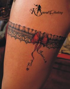 a woman's thigh with a bow and ribbon tattoo on her left side leg