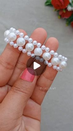 someone is holding some fake pearls in their hand