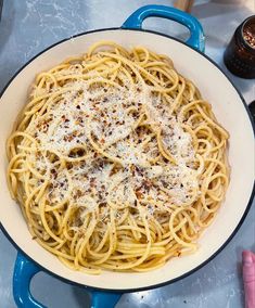 a pan filled with pasta and sauce on top of a table