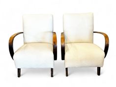 a pair of white chairs sitting next to each other