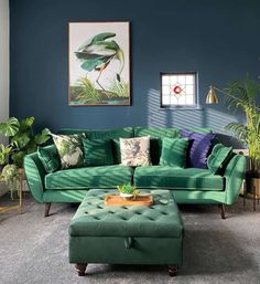 a living room with blue walls and green furniture