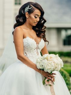 a woman in a wedding dress holding a bouquet