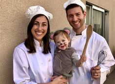 a man and woman in chef outfits holding a baby