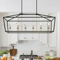 a kitchen with white cabinets and an island in front of the countertop is lit by candles