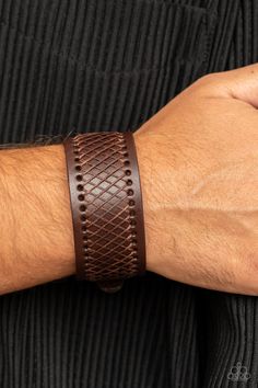 Shiny brown cording boldly crisscrosses across the front of a thick brown leather band, creating an edgy centerpiece around the wrist. Features a buckle closure. Sold as one individual bracelet. Adjustable Brown Leather Bracelet With Belt Detail, Brown Leather Bracelet With Wrist Strap, Adjustable Brown Leather Belt Bracelet, Brown Leather Braided Bracelet, Brown Braided Leather Bracelets, Rugged Brown Leather Bracelet, Brown Bracelet, Brown Jewelry, Trendy Fashion Jewelry