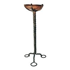 a metal floor lamp with an iron base