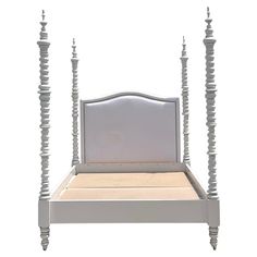 a white bed frame with four posts on the top and bottom side, in front of a white background