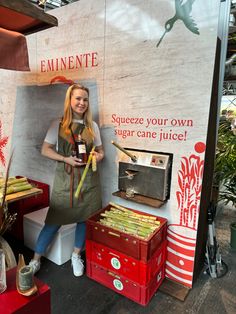 a woman standing in front of a booth selling food