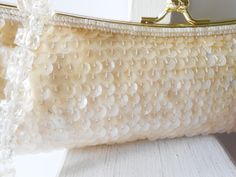 "Sparkly cream beaded evening bag. This bag really sparkles. The La Regale bag is covered with sequins and beads in a creamy pearly color. It has a goldtone frame and a kiss lock. The interior of the bag is cream satin and it contains one pocket. This is a beaded clutch handbag plus it has a short bead handle.A very glamorous evening bag that you will use for many occasions. A very neutral color. MATERIAL: Beads and sequins CONDITION: It is in good condition SIZE: It measures 10.5\" wide and 4\" Rectangular Sequined Bags For Weddings, Beige Pearl Embroidered Evening Bag For Wedding, Rectangular Sequin Bags For Wedding, Rectangular Sequin Bags For Weddings, Cream Evening Bag With Pearl Embroidery For Wedding, Beige Beaded Bags For Wedding, Rectangular Sequin Bag For Wedding, Beaded Cream Bags For Wedding, Embellished Cream Evening Bag For Wedding