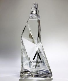 an award is displayed on a white surface with light coming from it's side