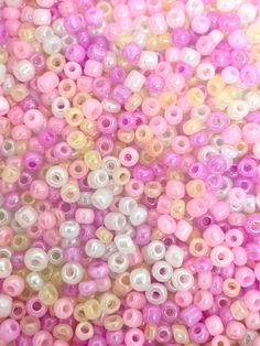 pink, yellow and white beads are arranged in rows