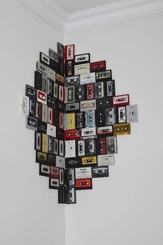 a bunch of cassette tapes are arranged in the shape of a sunburst on a wall