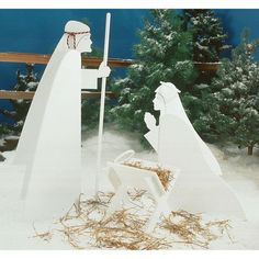 a nativity scene with two white figures in the snow