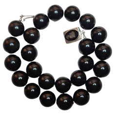 The necklace is 21 inches (53 cm) long, and the beads are 20 mm in size. Large, round obsidian beads are quite rare. The color of the beads is uniformly black with a glossy sheen. The color is authentic and natural. No thermal or other mechanical treatments were used. The necklace is fastened with a vintage, rare, silver Black Onyx Intaglio cameo clasp. The weight of the necklace is 240 grams (8.5oz). Obsidian stone is naturally formed volcanic glass. Obsidian received its name from the name of Ancient Roman Warrior, Noblesse Oblige, Black Obsidian Necklace, Roman Warriors, Twist Beads, Deco Beads, Obsidian Necklace, Carnelian Necklace, Obsidian Stone