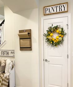 a door with a wreath on it and a sign that says pantry above the door