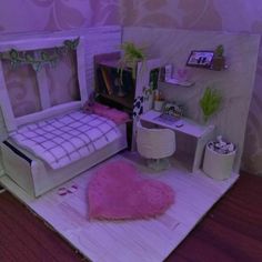 a dollhouse bedroom with a bed and desk