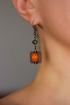 Beautiful and unique boho earrings with orange czech glass faceted 10 mm, green irregular shape glass beads, antique brass  square charms and antique brass earring hooks. Earring hooks are from nickel free and lead free metal. Unique jewelry for your boho outfit or a great gift for someone special! *The total lenght of earrings is about 49 mm including earring hooks. Other earrings of my shop you can see here: https://www.etsy.com/shop/NaTavelli?section_id=13757927  Thanks for visit. Unique Dangle Earrings, Earrings Fall, Boho Outfit, Beads Earrings, Green Beads, Earrings Long, Earring Hooks, Brass Earrings, Green Bead