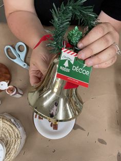 a person is decorating a bell shaped christmas tree