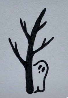 a black and white drawing of a tree with a ghost drawn on it's trunk