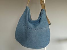 a denim purse hanging on a hook